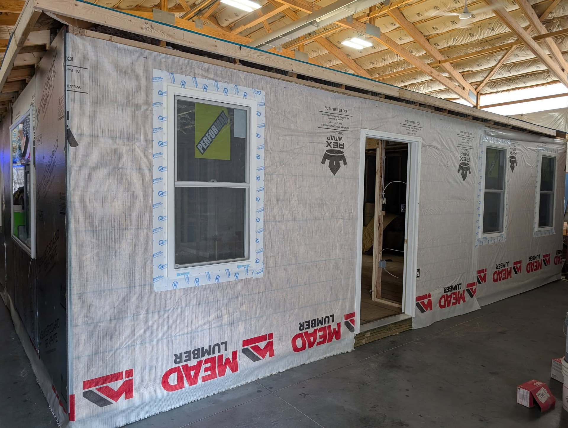 House framing wrapped and windows installed in the shop