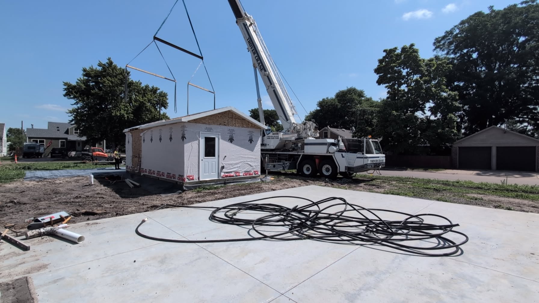 Crane setting the first module on the foundation